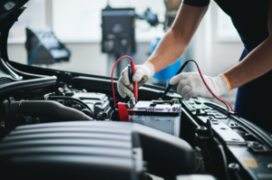 Professional mechanic testing and replacing car battery at Hyperion Auto Repair Los Angeles