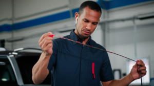 Professional mechanic checking transmission fluid at Hyperion Auto Repair in Los Angeles