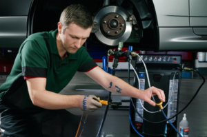 Professional mechanic performing brake fluid flush service at Hyperion Auto Repair in Los Angeles