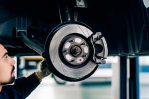 Professional mechanic performing brake pad replacement and rotor inspection at Hyperion Auto Repair in Los Angeles