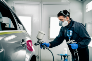 Professional paint scratch repair technician using color matching technology at Hyperion Auto Repair in Los Angeles